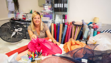 Woman making hats for Hats by Caroline.